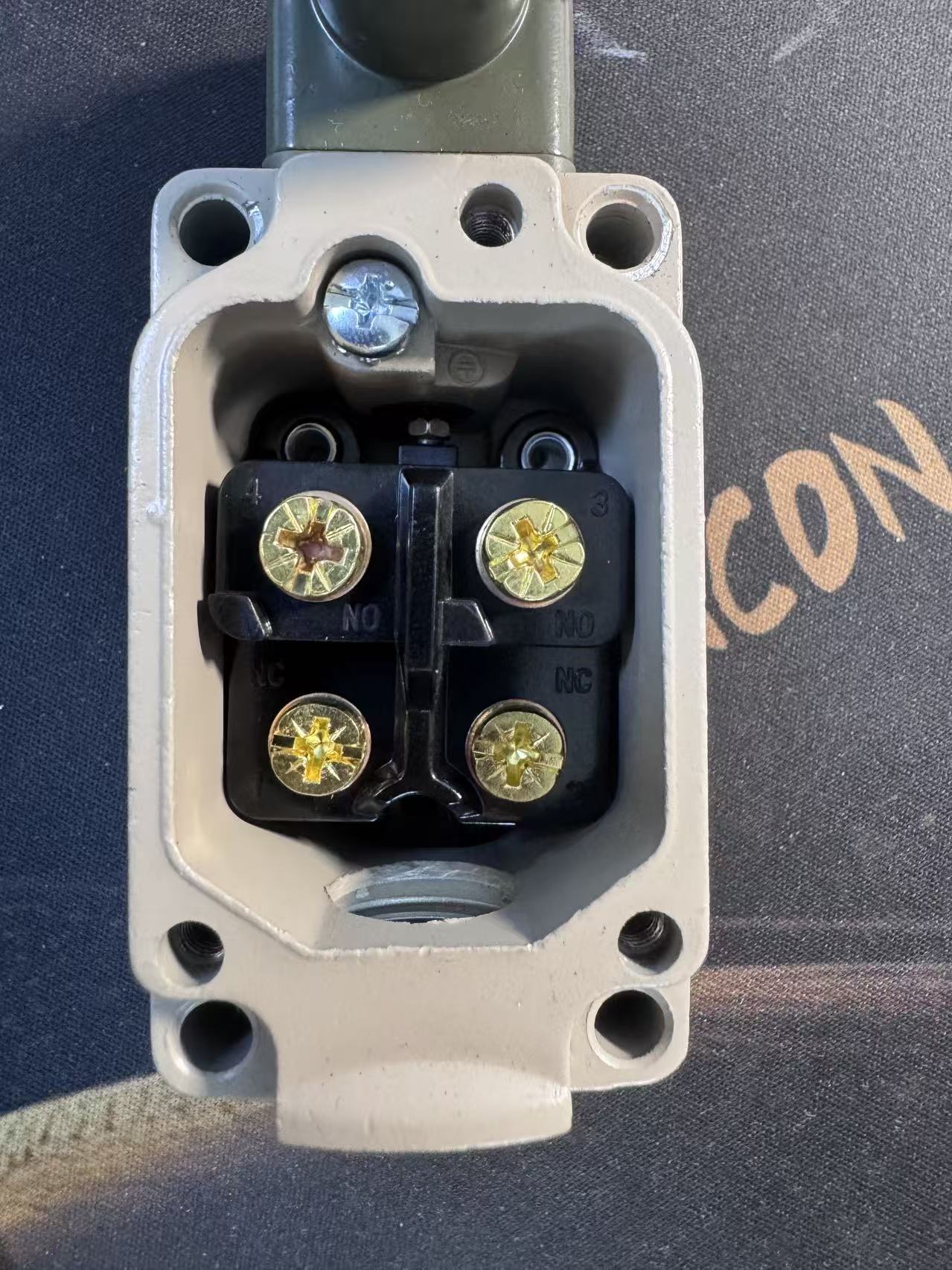 Multimeter probe placement across common and normally closed terminals